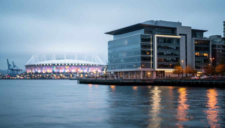 Vancouver waterfront at dusk showing modern buildings, water reflections, and a distant stadium glow suggesting civic and sports news in 2026.